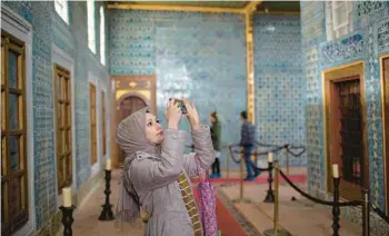  ?? DANIELLE VILLASANA/THE NEW YORK TIMES ?? A woman takes pictures in the Hunkar Kasri complex in Istanbul.