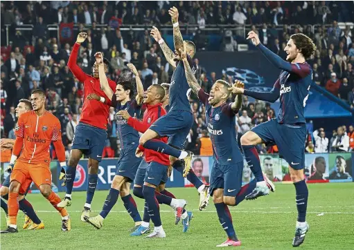  ?? — AP ?? Memorable win: Paris St Germain players celebratin­g their 3- 0 win over Bayen Munich in the Champions League match on Wednesday.