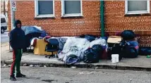  ?? BILL TORPY / BTORPY@AJC.COM ?? Will Woods stands near a mountain of belongings owned by him and other homeless men who camp out under the tunnel near Grady Memorial Hospital.