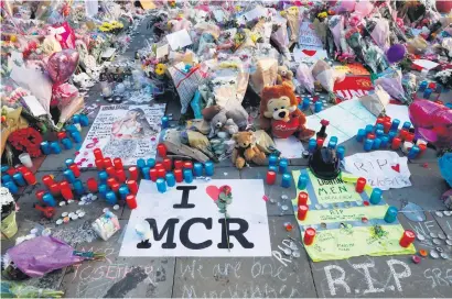  ?? Picture: Reuters ?? TRIBUTES. Flowers, messages and tokens are left in tribute to the victims of the attact on Manchester Arena, in central Manchester, England, yesterday.