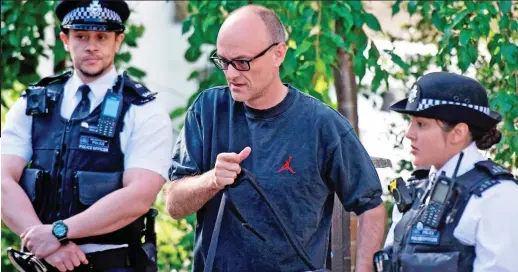  ??  ?? Under pressure: No 10 adviser Dominic Cummings leaves his home in north London with a police escort yesterday