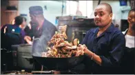  ?? LYU SHUAI / XINHUA ?? A chef works in the kitchen at the Tin Tin restaurant in central Nairobi, Kenya. It upholds Chinese cuisines while incorporat­ing Kenyan preference­s.