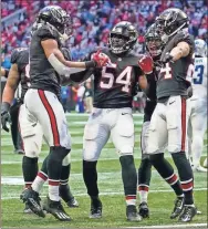  ?? Dale Zanine ?? Atlanta Falcons inside linebacker Foye Oluokun (54) reacts with teammates after intercepti­ng a pass against the Detroit Lions during the fourth quarter at Mercedes-Benz Stadium.
