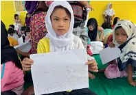  ?? Reuters ?? A student show her drawing about what she and other Marawi residents experience­d before fleeing the city still under siege during a school day at Pantar school in Lanao Del Norte. —