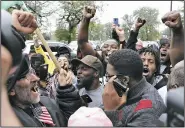  ?? AP/NAM Y. HUH ?? Protesters gathered in front of a courthouse Friday in Chicago get the news about the conviction of white police officer Jason Van Dyke in the fatal shooting of black teenager Laquan McDonald.