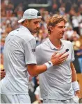  ?? THE ASSOCIATED PRESS ?? Kevin Anderson, right, meets John Isner at the net after defeating him in a marathon semifinal Friday at Wimbledon. Anderson won 7-6 (6), 6-7 (5), 6-7 (9), 6-4, 26-24 in a match that lasted 6 1/2 hours.