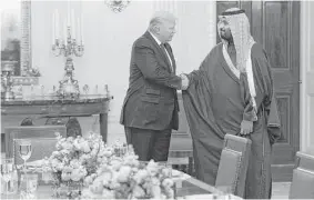  ?? Evan Vucci / Associated Press ?? President Donald Trump shakes hands in March with Saudi Deputy Crown Prince Mohammed bin Salman at the White House.