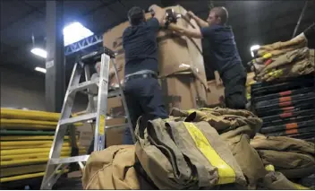  ?? JOHN MINCHILLO — THE ASSOCIATED PRESS ?? Volunteers with Razom for Ukraine, a New York-based nonprofit, pack firefighti­ng and medical donations for shipment to Ukraine on Feb. 8 in Woodbridge Township, N.J.