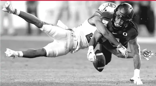  ?? GETTY IMAGES ?? Oregon safety Jevon Holland, breaking up a pass against Utah, ran a 4.47 in the 40-yard dash and has played cornerback. That’s promising for his coverage skills.