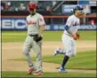  ?? FRANK FRANKLIN II — ASSOCIATED PRESS ?? As Phillies relief pitcher Victor Arano walks off the field, Mets’ Wilmer Flores rounds third and heads home after hitting his game-winning homer in the first game of Monday’s doublehead­er at Citi Field in New York.