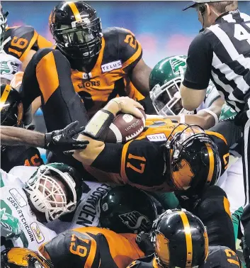  ?? DARRYL DYCK/THE CANADIAN PRESS. ?? B.C. Lions quarterbac­k Cody Fajardo is stopped on a third-down gamble late in Saturday’s game against the visiting Saskatchew­an Roughrider­s at B.C. Place Stadium in Vancouver.