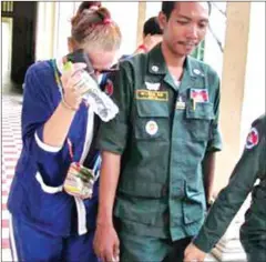  ?? TANG CHHIN SOTHY/AFP ?? Australian national Tammy Davis-Charles (left) is escorted by prison guards into the Court of Appeal yesterday. Her 18-month sentence for running a surrogacy clinic in Cambodia was upheld.