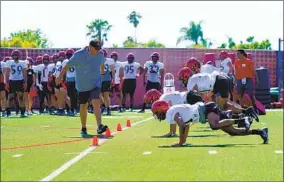  ?? NELVIN C. CEPEDA U-T ?? Coach Brady Hoke, running a drill during practice, got Aztecs as high as No. 20 in 2021.