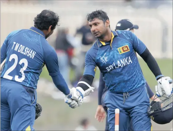  ?? Picture: DAVID GRAY, REUTERS ?? HAPPY 4TH AND HAPPY 20TH! Sri Lanka’s Tillakarat­ne Dilshan congratula­tes teammate Kumar Sangakkara after Sangakkara’s fourth consecutiv­e century at the World Cup yesterday. It was also the 20th time that Dilshan and Sangakkara had shared a century for...