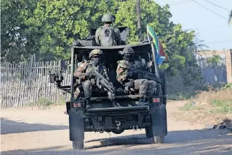  ?? ?? SOUTH African soldiers, who are part of the SADC peacekeepi­ng mission in Mozambique, patrol the Maringanha district in Pemba, in August 2021. A video on social media shows some SANDF members allegedly participat­ing in controvers­ial activities and raised the alarm about possible human rights violations, says the writer. | AFP