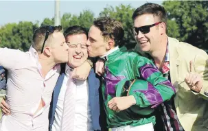  ?? Picture: JC Photograph­ics ?? KISSING COUSINS. Assistant trainer Mathew de Kock gets a kiss from owner Mike Shea and jockey Callan Murray while co-owner Murray Makepeace joins in after Takingthep­eace won the Gauteng Fillies Guineas at Turffontei­n. Should the three-year-old filly...