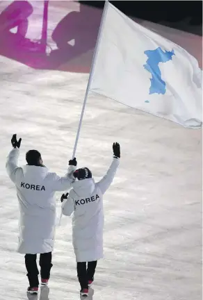  ?? SEAN M. HAFFEY/AFP/GETTY IMAGES ?? United at the Games: Unified Korea’s flag-bearers were South Korean bobsledder Won Yun-jong, left, and North Korean hockey player Hwang Chung Gum.