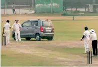  ?? PTI file ?? Gautam Gambhir and other players look on as a car is driven onto the pitch during the Delhi versus Uttar Pradesh Ranji trophy cricket match at the Palam ground. —