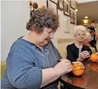  ?? ?? Residents June and Margaret decorate oranges