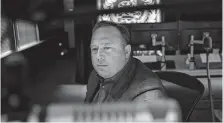  ?? Ilana Panich-linsman / New York Times ?? Alex Jones, the conservati­ve conspiracy theorist and host of Infowars.com, mans the control room at his Austin office.