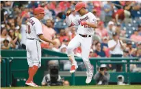  ?? NICK WASS/AP ?? Nationals star Juan Soto, right, celebrates his home run with third-base coach Gary DiSarcina during the eighth inning of a 7-3 victory.