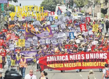  ?? Michael Owen Baker For The Times ?? DEMONSTRAT­ORS MARCH through downtown L.A. during a Labor Day protest. The event, organized by the Service Employees Internatio­nal Union, was a rebuke of lawmakers opposed to raising the minimum wage.