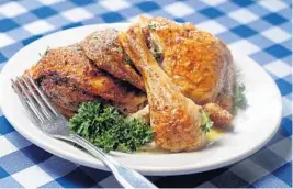  ?? SUSAN STOCKER/SUN SENTINEL ?? After a pass under the broiler, the crisp, golden brown roast chicken ladoregano is brushed with a lemony oregano sauce at Greek Islands Taverna in Fort Lauderdale.