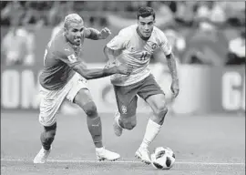  ?? Joe Klamar Agence France-Presse/Getty Images ?? SWITZERLAN­D MIDFIELDER Valon Behrami, left, and Brazil forward Philippe Coutinho compete for the ball during an opening game in Rostov.