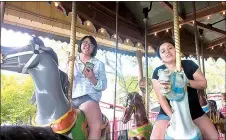  ?? Photo by Makayla James ?? Seniors Shaney Lee (left) and Isabel Rodriguez take a break from the thrilling rides to relax on the carousel before the park closed.