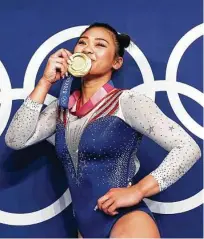  ?? Laurence Griffiths / Getty Images ?? Sunisa Lee of Team USA poses with her gold medal after winning the women’s all-around final on July 29.