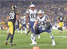  ??  ?? New England tight end Rob Gronkowski celebrates after scoring on a two-point conversion that gave the Patriots a 27-24 lead late in their win at Pittsburgh. PHILIP G. PAVELY/USA TODAY SPORTS