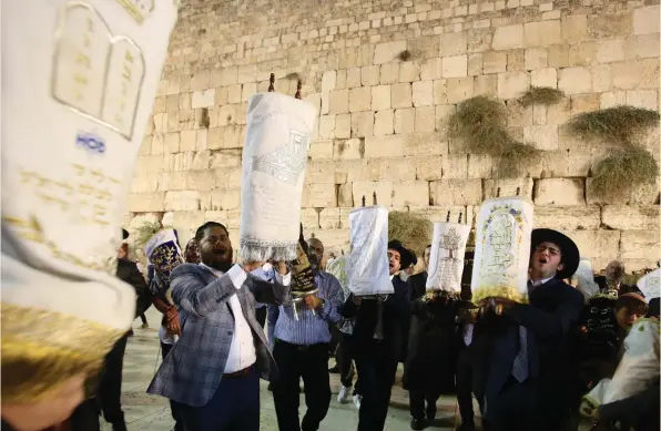  ?? (Marc Israel Sellem/The Jerusalem Post) ?? People dance with Torah scrolls at a ‘Second Hakafot’ celebratio­n at the Western Wall last night. The custom goes back to the 16th-century Safed Rabbi Isaac Luria Ashkenazi.