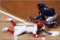  ?? MATT SLOCUM — THE ASSOCIATED PRESS ?? The Phillies’ Andrew McCutchen, bottom, scores past Braves catcher Travis d’Arnaud on a sacrifice fly by Rhys Hoskins in the first inning.