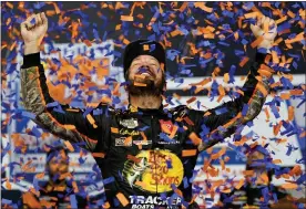  ?? STEVE HELBER — THE ASSOCIATED PRESS ?? Martin Truex Jr., celebrates winning the NASCAR Cup series auto race in Richmond, Va., Saturday.