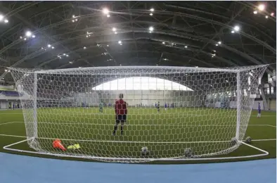  ??  ?? This photo taken on Thursday, May 17, 2018, shows an indoor football pitch at the Olympic Sports Center in Saransk, Russia. Russia is trying to wipe its sports reputation clean by hosting the World Cup after years of doping scandals. In the host city...