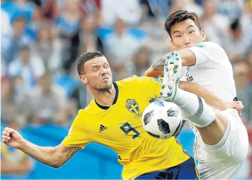  ?? Picture: REUTERS/MURAD SEZER ?? TAKING FLIGHT: South Korea’s Jang Hyun-soo tries to fend off Sweden’s Marcus Berg in their World Cup Group F match in Nizhny Novgorod, Russia, yesterday