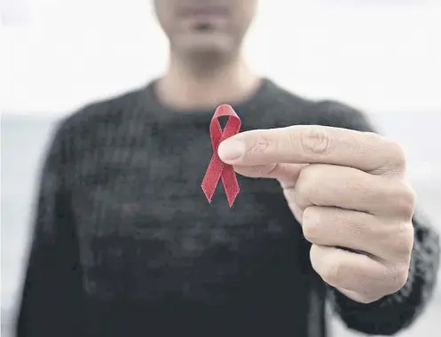  ?? ?? ↑ The red ribbon is worn as a symbol of awareness and solidarity on World AIDS Day, which takes place today