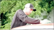  ??  ?? Wyatt Grogan, a 2016 graduate of Farmington High School, dries off his 1965 red Ford Mustang.