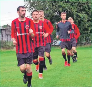  ?? Photograph: Scott Currie, BBC. ?? Arran AFC players during their pre-match warm-up and prior to the torrential rain.