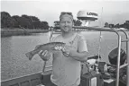  ?? ?? Slagle holds one of the fist collected in an electrofis­hing survey in Lake Erie. The electrofis­hing crew collects data for use by scientists, university students and fishermen.