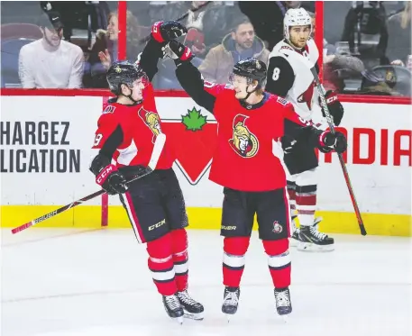  ?? ERROL MCGIHON ?? Senators’ Drake Batherson, left, celebrates Vladislav Namestniko­v’s goal Thursday as Arizona’s Nick Schmaltz skates by.