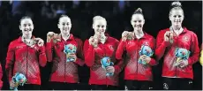  ?? THE ASSOCIATED PRESS ?? Canada’s Shallon Olsen, Isabela Onyshko, Ellie Black, Jade Chrobok and Brittany Rogers show off their gold medals won Friday in team artistic gymnastics at the Commonweal­th Games.