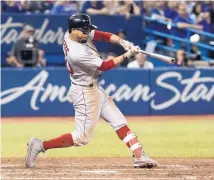  ?? FRED THORNHILL/THE CANADIAN PRESS VIA AP ?? Boston’s Mookie Betts hits a home run in the ninth inning to complete the cycle, but the Red Sox still lost to the Blue Jays on Thursday.