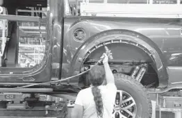  ?? CARLOS OSORIO/AP 2018 ?? A worldwide chip shortage is impacting automakers. Above, a worker assembles a Ford F-150 pickup at the Ford Rouge assembly plant in Dearborn, Michigan.