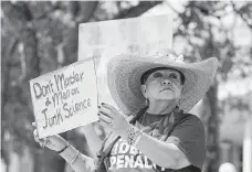  ?? Jason Fochtman / Staff photograph­er ?? Diane Conkling holds up a sign against capital punishment Tuesday as she and others gather in support of Larry Swearingen outside the Montgomery County Courthouse in Conroe.