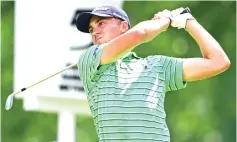  ?? AP Photo/David Dermer ?? Justin Thomas watches his tee shot on the fifth hole during the final round of the Bridgeston­e Invitation­al golf tournament at Firestone Country Club on Sunday in Akron, Ohio.