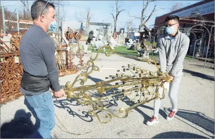  ?? Ned Gerard / Hearst Connecticu­t Media ?? Edwardo Navarro, left, and his son Steven prepare to load a large chandelier into their van at United House Wrecking in Stamford on Nov. 27. Navarro said the chandelier was heading to a house he is renovating in Westport.