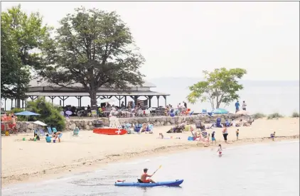  ?? Bob Luckey Jr. / Hearst Connecticu­t Media ?? A kayaker paddles in Long Island Sound off Island Beach on Saturday, the day a ceremony was held commemorat­ing the 100th anniversar­y of the island’s donation to the town.