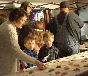  ??  ?? Holly Harp Kelton and family are having a cookie after having gone through the Atlanta State Park’s annual Christmas decoration drive-through.