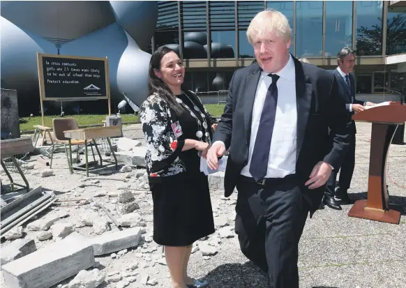  ?? AP; AFP ?? Andria Zafirakou with UK Foreign Secretary Boris Johnson at a Palace of Nations exhibition in Geneva. Below, Ms Zafirakou at the awards in Dubai